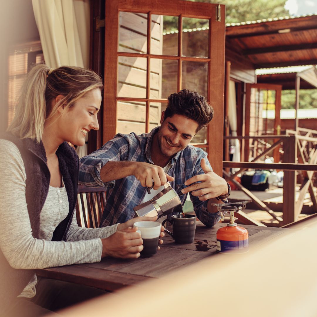 couple drinking coffee in a cabin