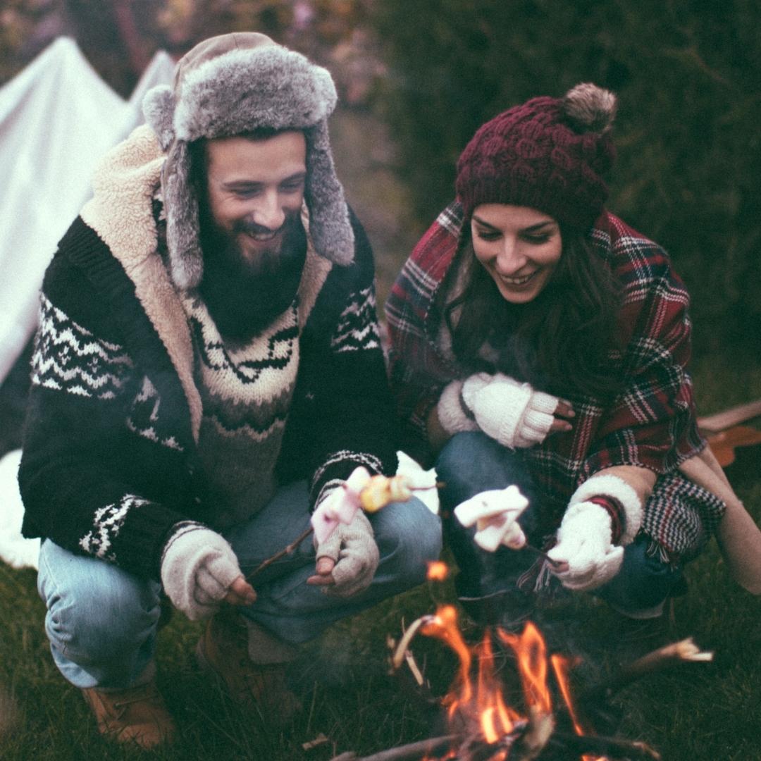 Happy couple roasting marshmallows
