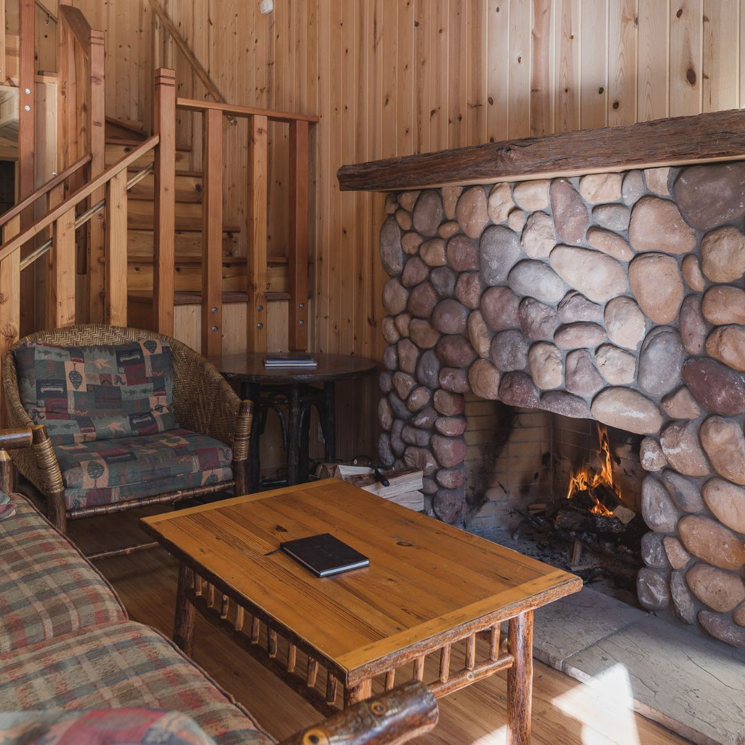 cozy fire in fireplace with stone surround in cabin 