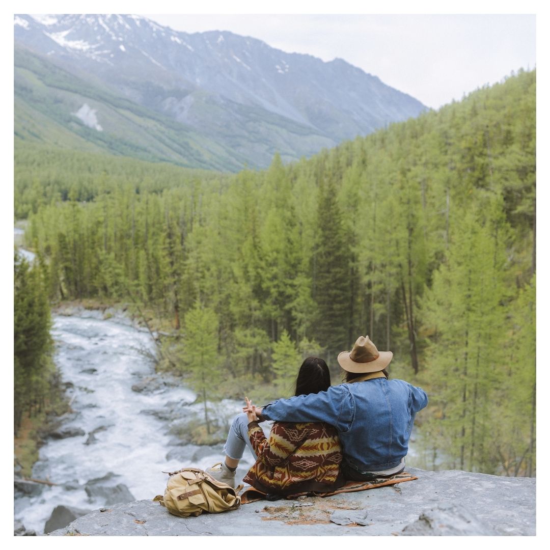 couple sitting by a river