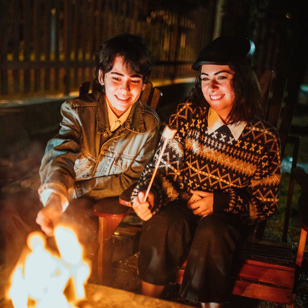 people at outdoor campfire in Sierra Nevada mountains roasting marshmallows